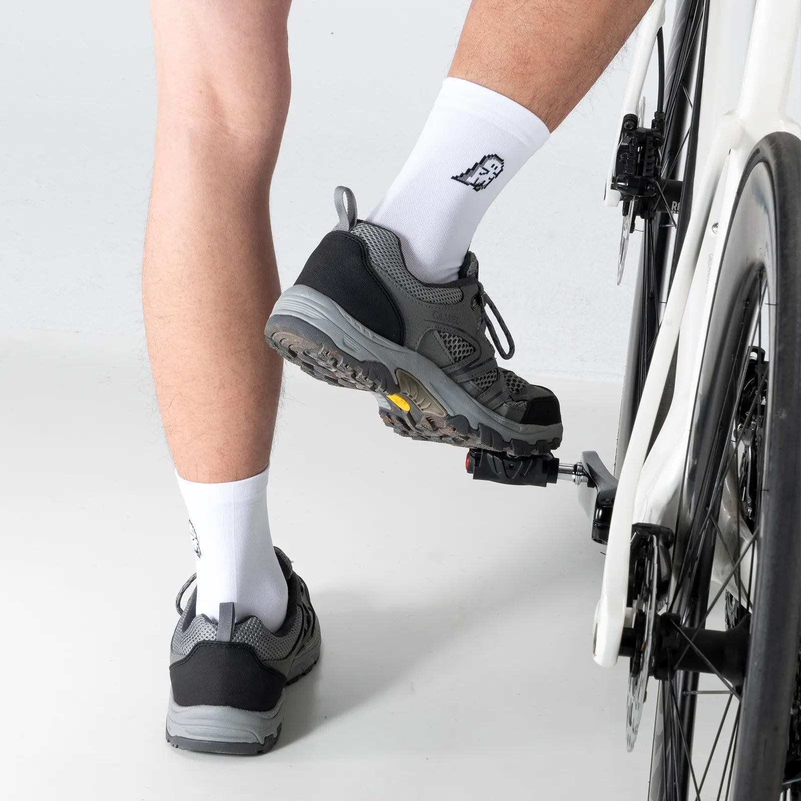 Side view of ROCKBROS black and white ghost print breathable mesh cycling socks on feet.
#color_white